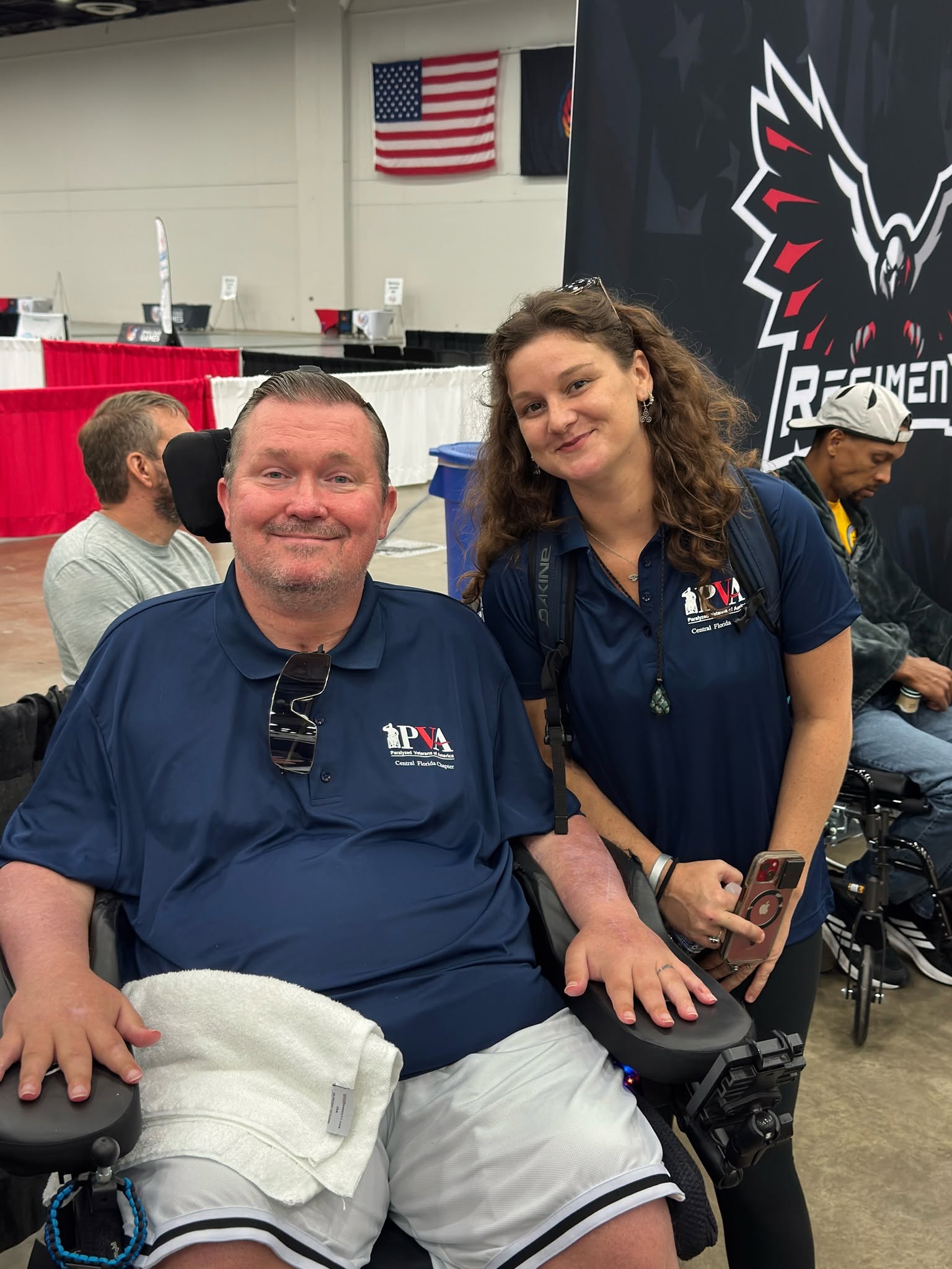 Charlie and Jenna smiling together at a Paralyzed Veterans of America event, representing a long-term caregiving relationship.