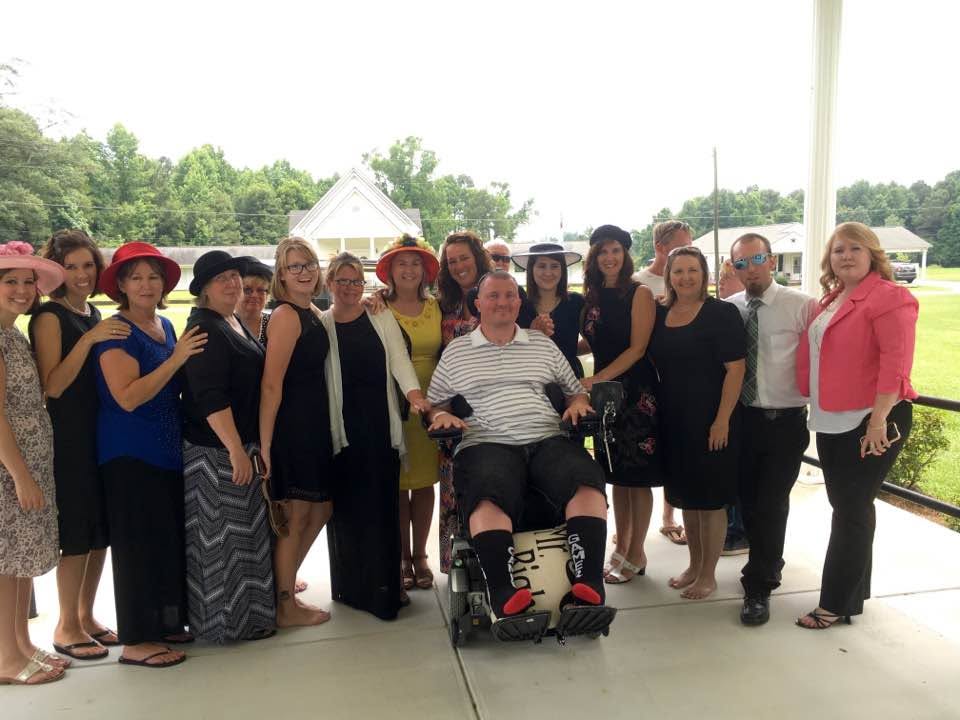 Charlie surrounded by his parents, aunts, cousins, and extended family, representing the family support network that is part of his village.
