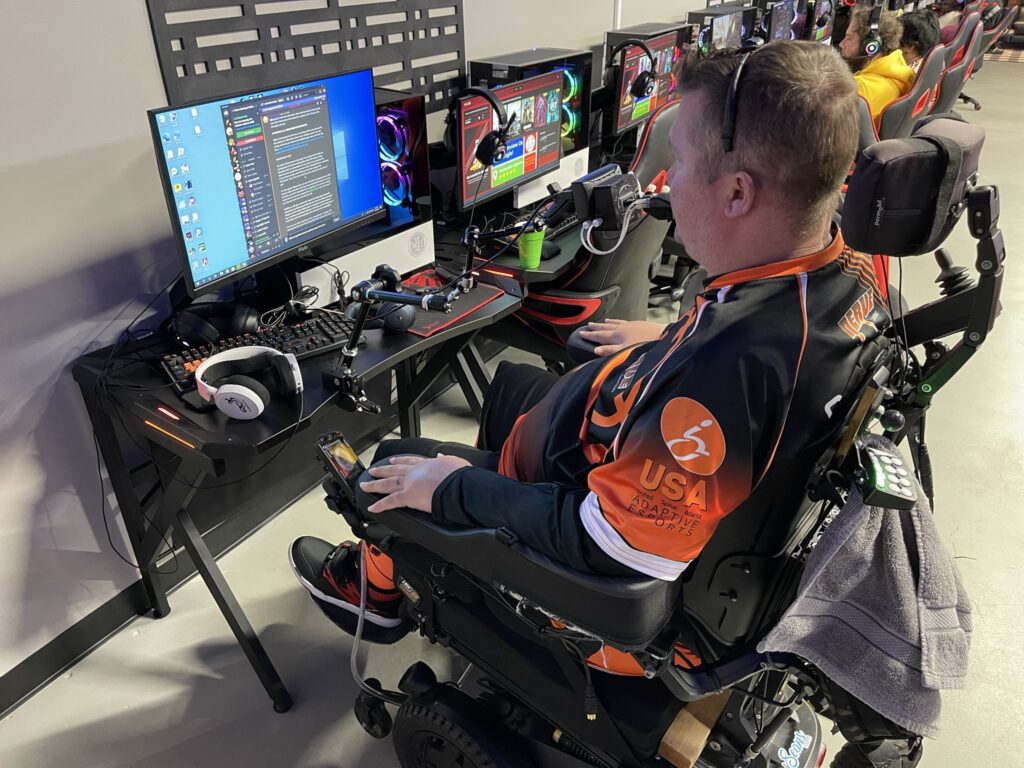 Charlie in his power wheelchair at his computer gaming setup.