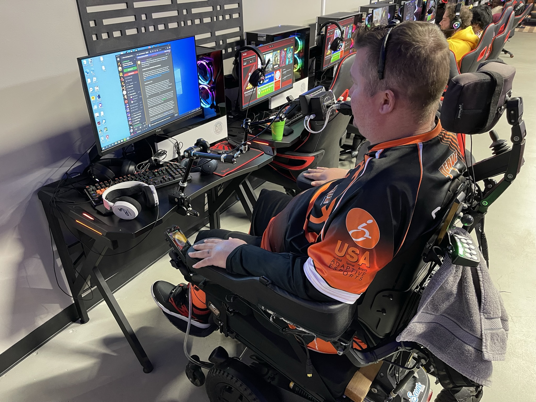 Charlie in his power wheelchair at his computer gaming setup.