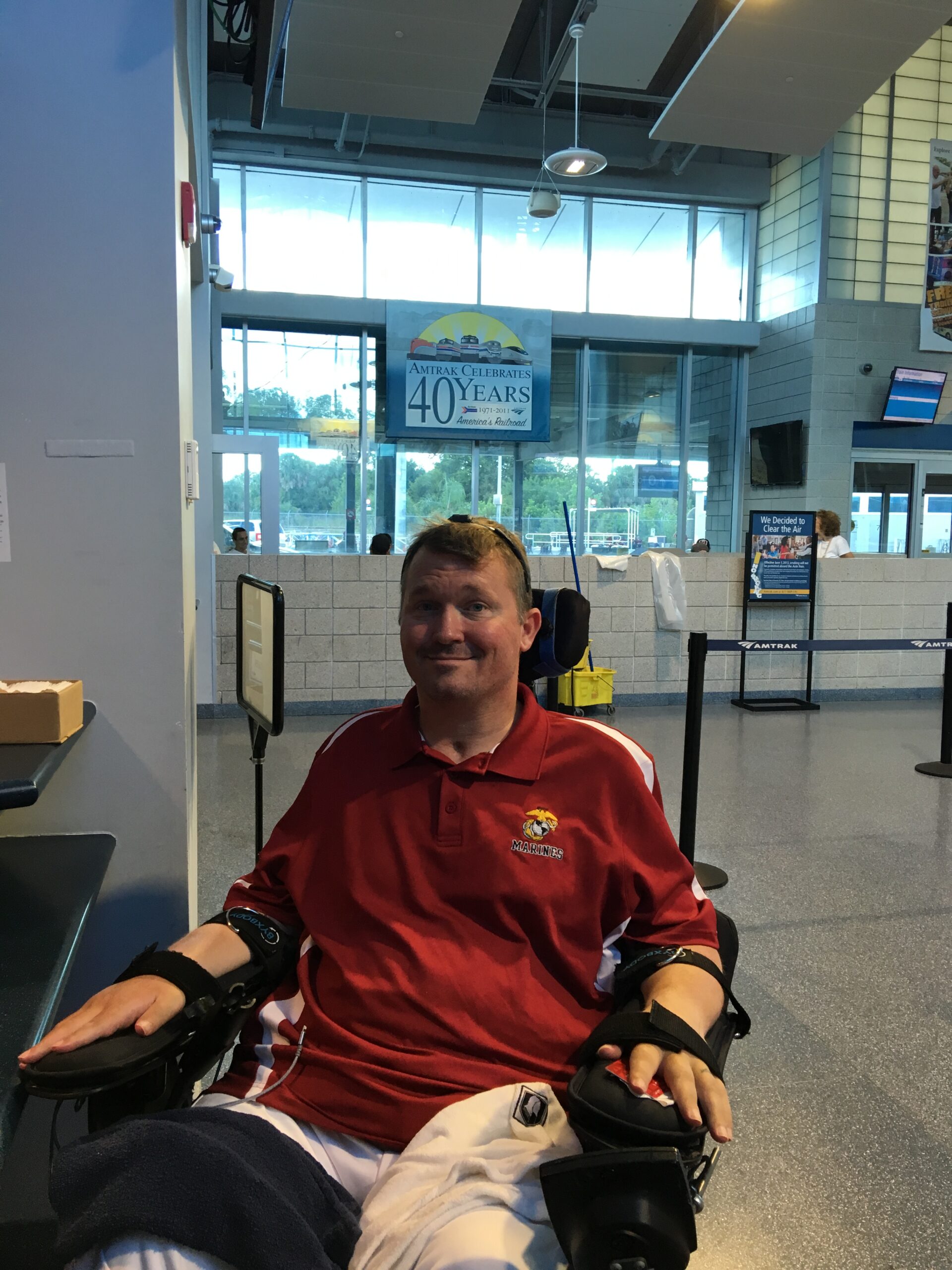 Charlie Merritt traveling through an airport in a power wheelchair