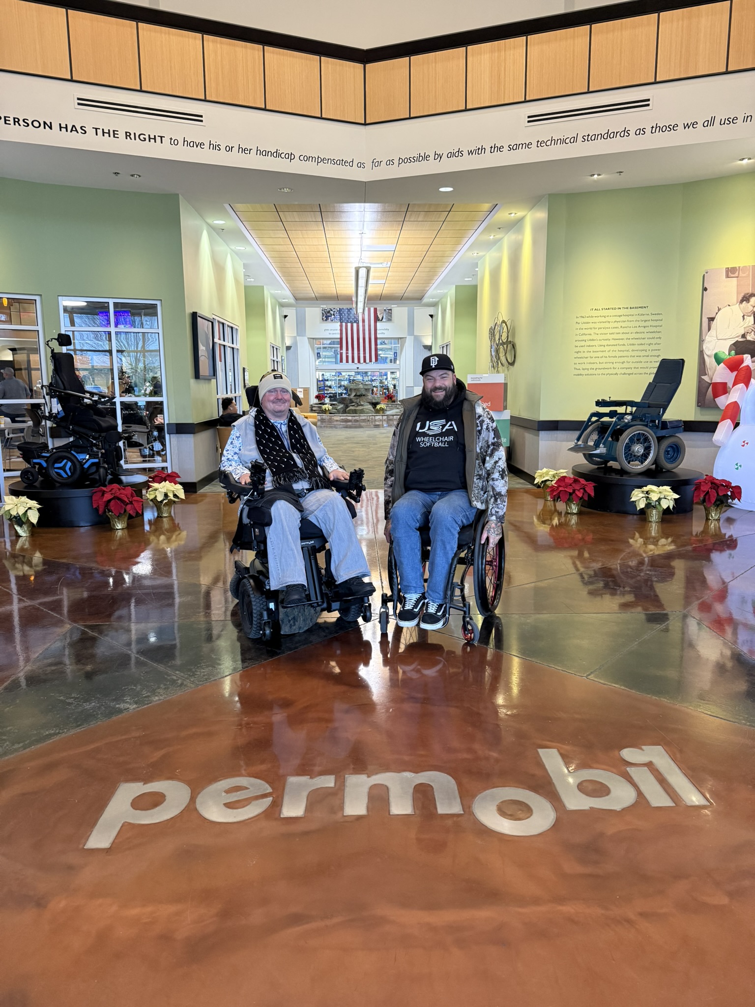 Charlie Merritt with a group at a Permobil showroom
