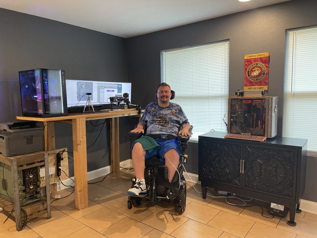 Power wheelchair user indoors near a television and fireplace.
