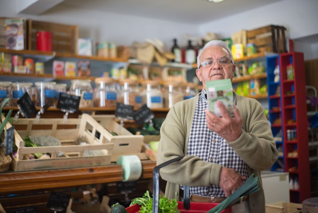 elderly man looking at a product